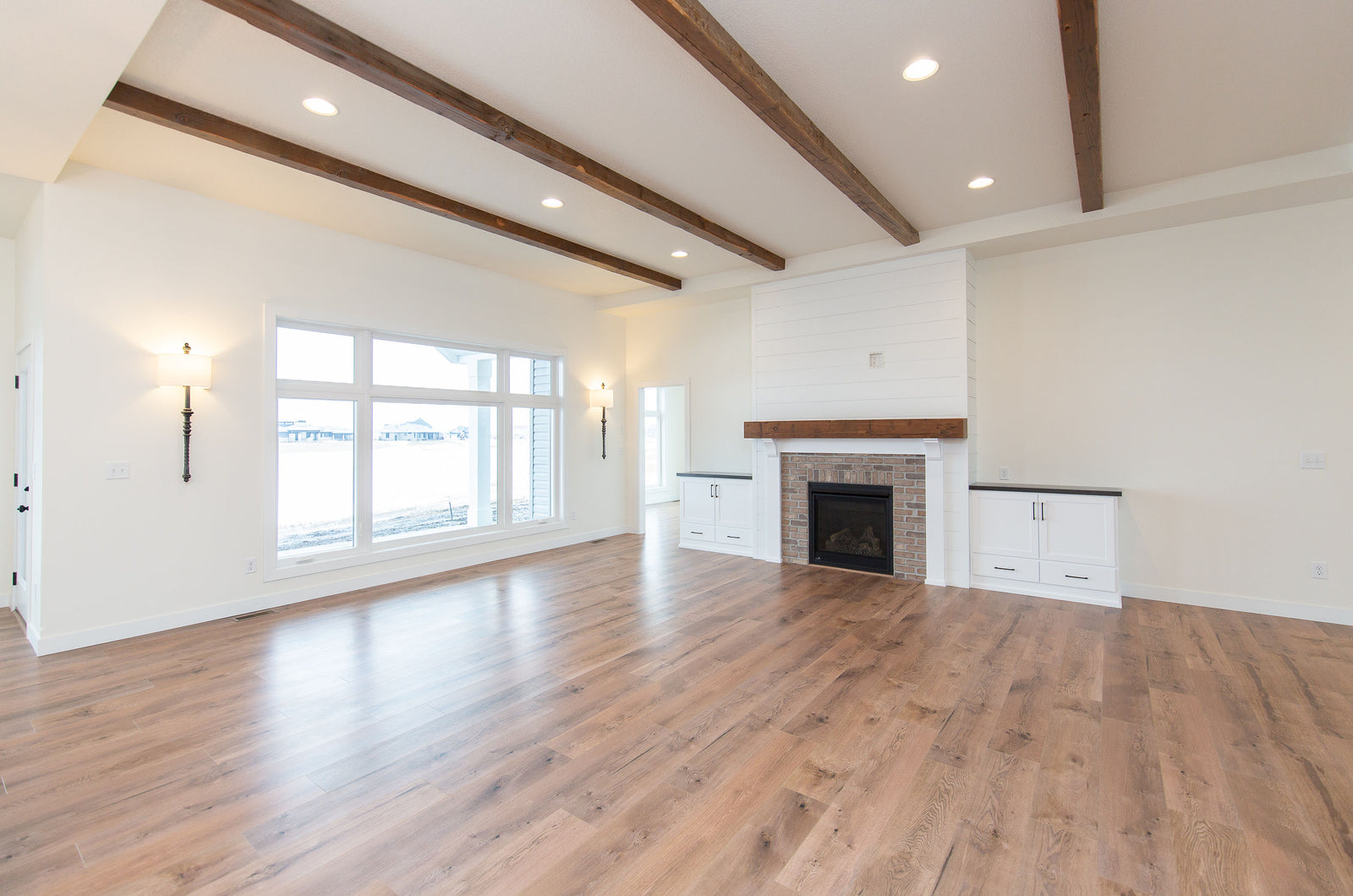 Dakota Timber Company Reclaimed Wood Ceiling Beams | Fargo, ND | Living Room With Timber Beams | Custom Wood Fireplace Mantel | Dakota Timber Co Mantels